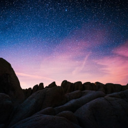 rock mountain during starry night