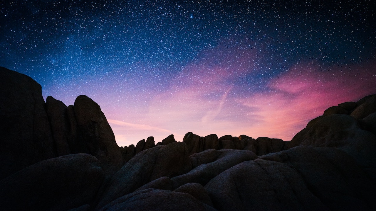 One night at Joshua Tree rock mountain during starry night